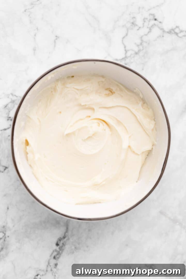 Mixing bowl containing the finished, smooth vegan cream cheese frosting.