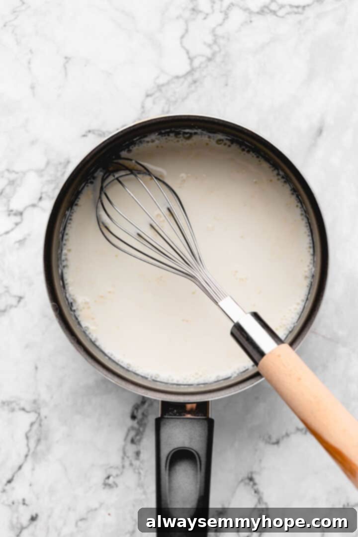 Overhead view of tangzhong ingredients in a saucepan after whisking but before cooking.