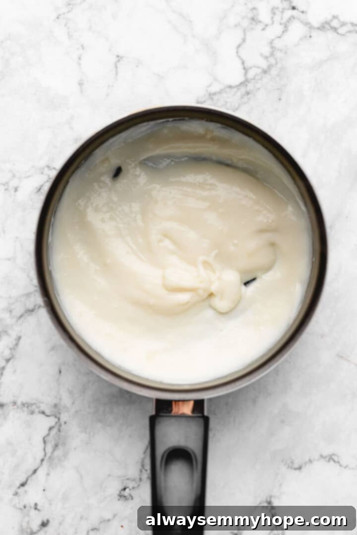 Overhead view of thick, cooked tangzhong in a small saucepan, ready to be chilled.