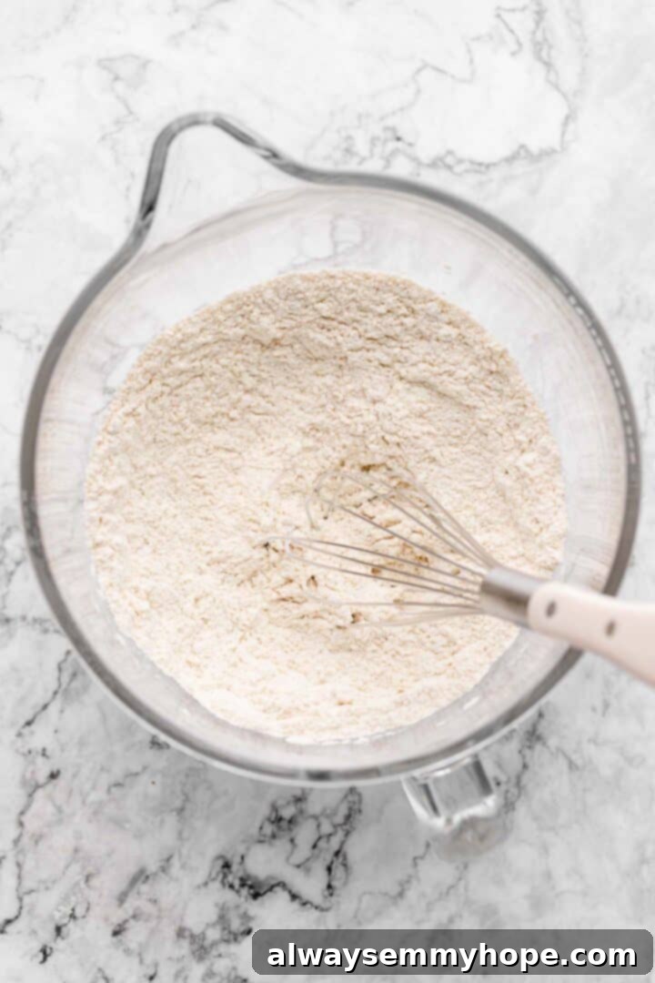 Another overhead view of dry ingredients for cinnamon roll dough, showing them whisked together.