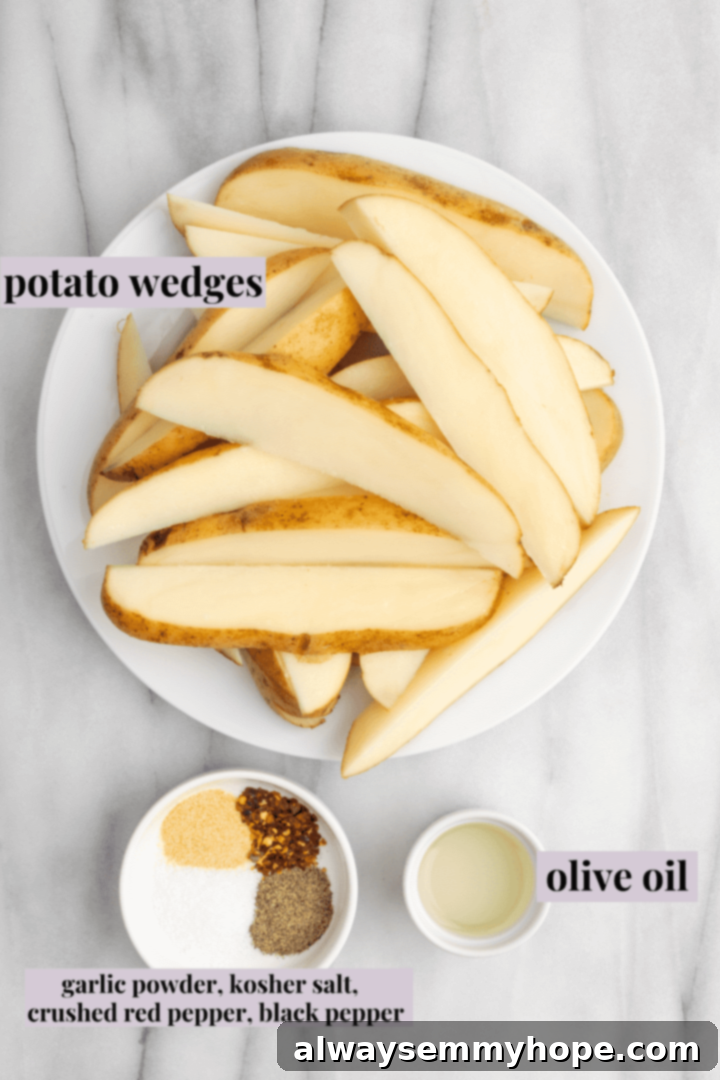 These quick and easy air fryer potato wedges are crispy on the outside, fluffy on the inside, and the perfect side for your burger. A flat lay arrangement displaying all the fresh ingredients needed for air fryer potato wedges, including whole russet potatoes, a bottle of olive oil, and small bowls filled with kosher salt, garlic powder, black pepper, and red pepper flakes.