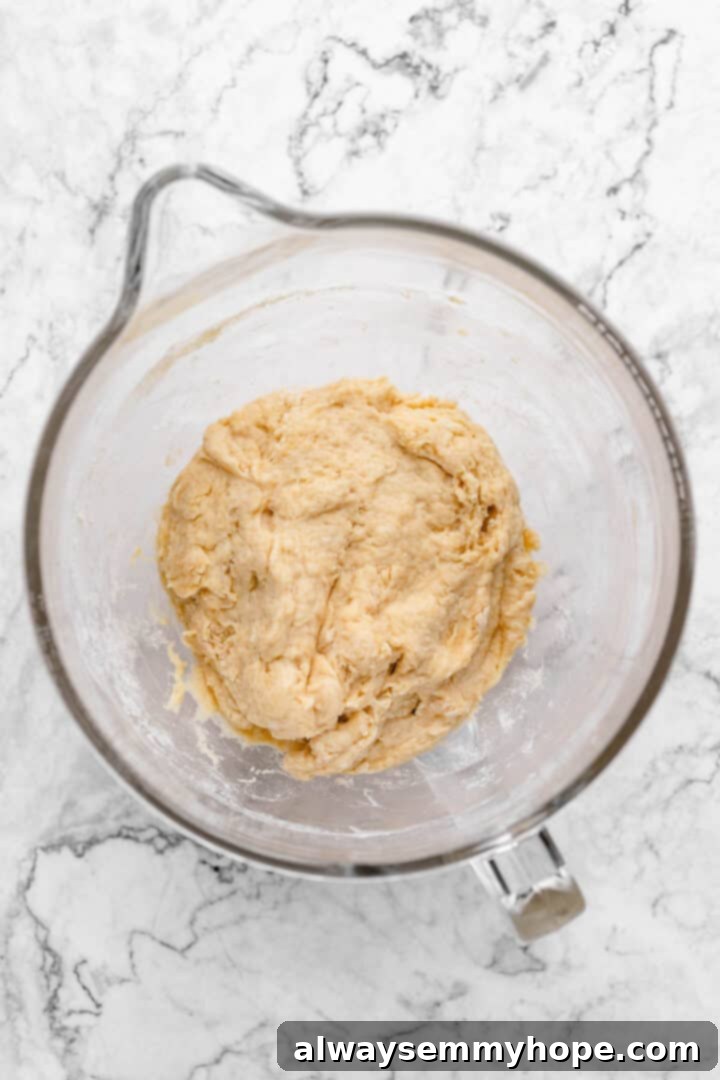 Fluffy Vegan Japanese Milk Bread 13 Overhead view of shaggy dough in glass mixing bowl