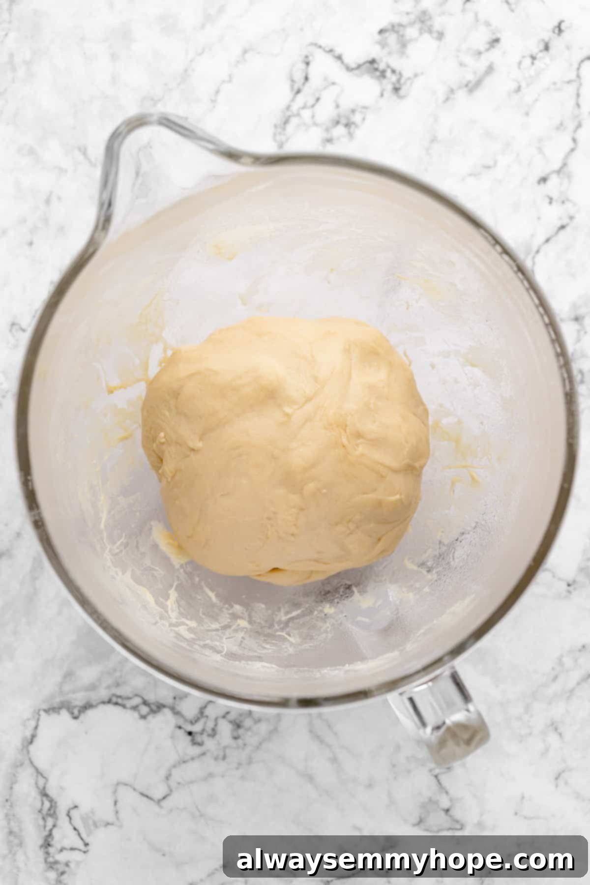 Fluffy Vegan Japanese Milk Bread 14 Overhead view of bread dough in glass mixing bowl