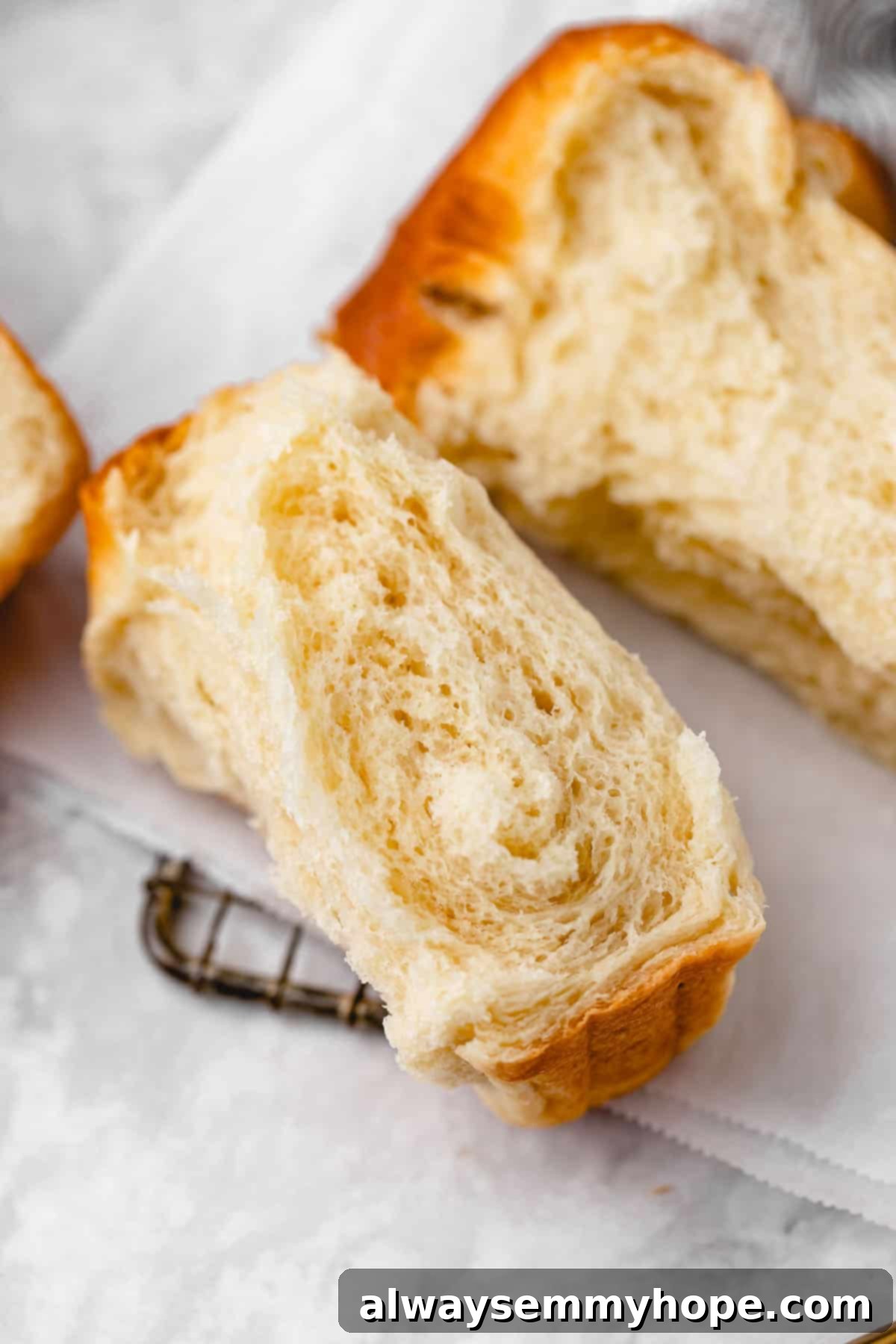 Fluffy Vegan Japanese Milk Bread 30 Piece of vegan milk bread torn in half, set on wire rack lined with parchment