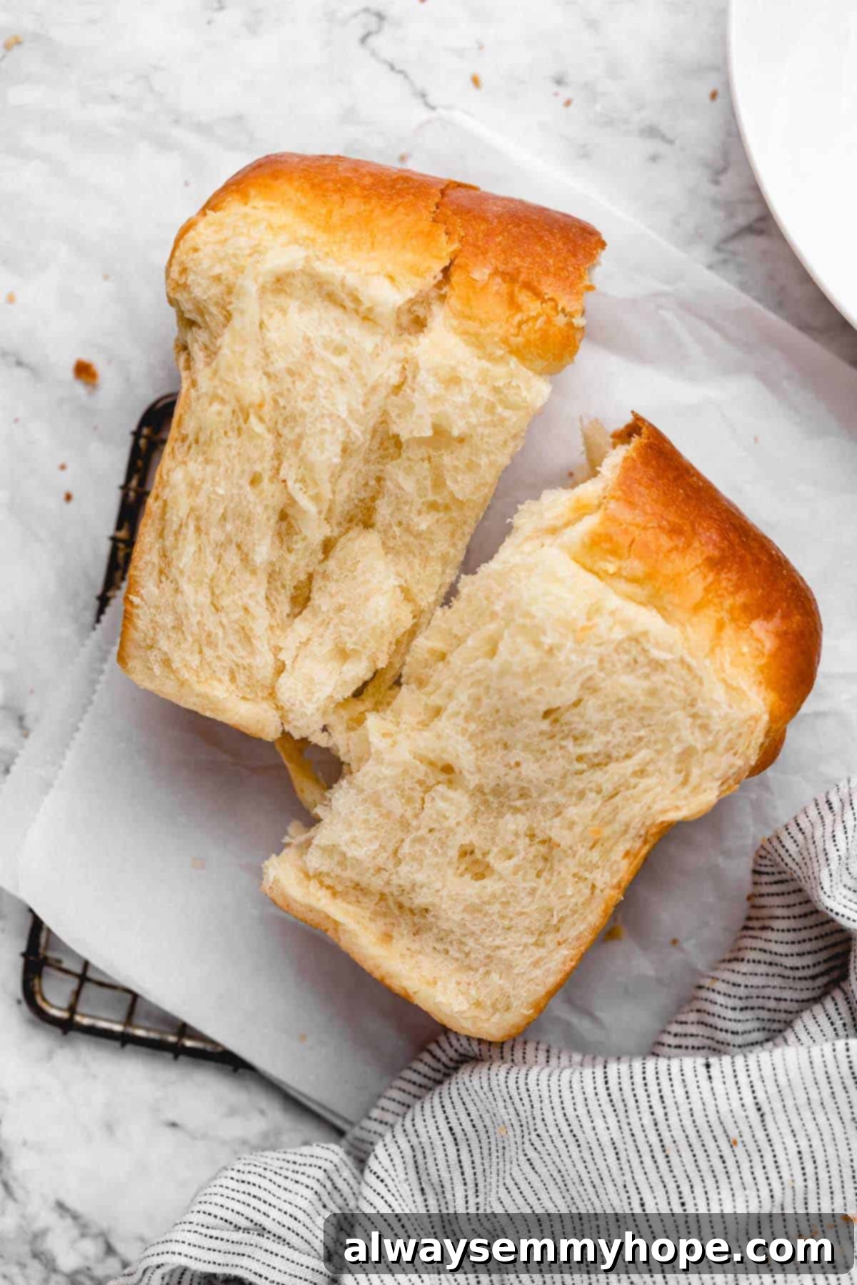 Fluffy Vegan Japanese Milk Bread 5 Piece of vegan milk bread torn in half, set on wire rack lined with parchment