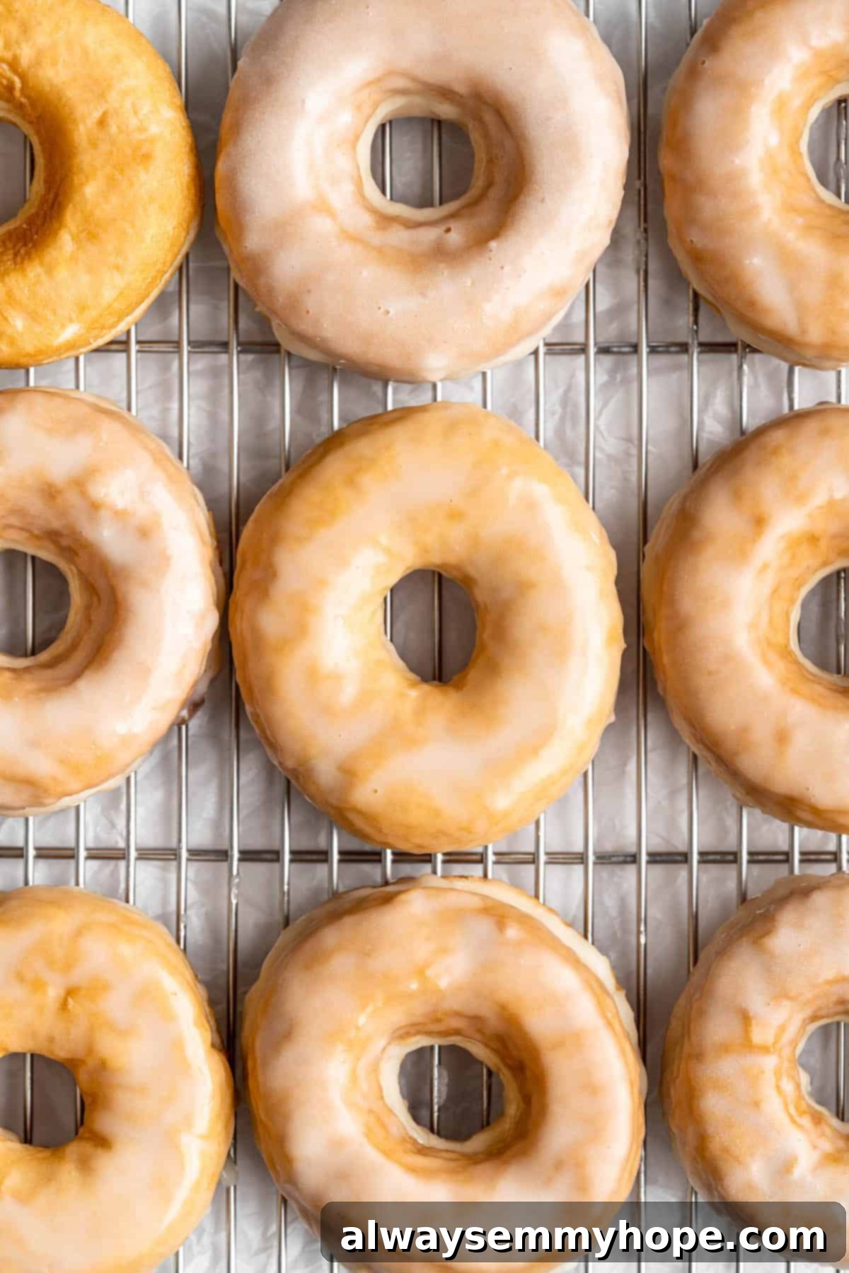 Freshly glazed vegan donuts cooling on a wire rack
