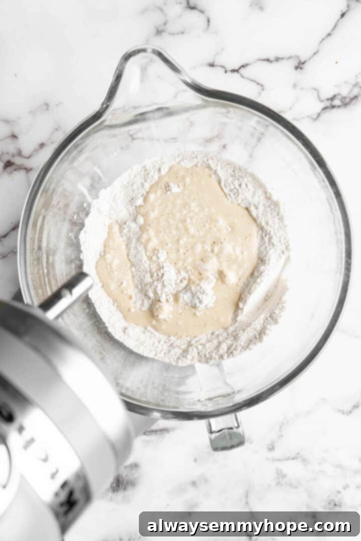 Wet and dry ingredients prepared in a stand mixer bowl before mixing