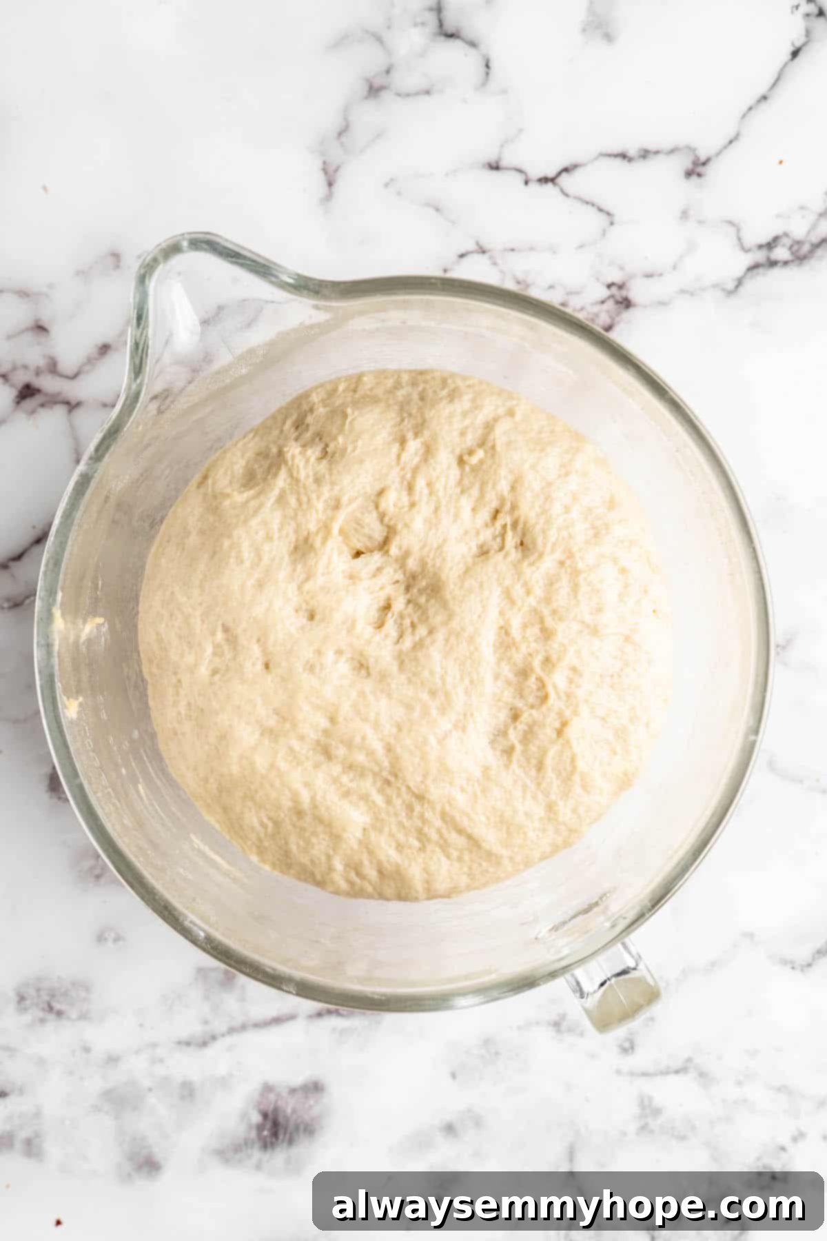 Donut dough after its first rise, visibly doubled in size