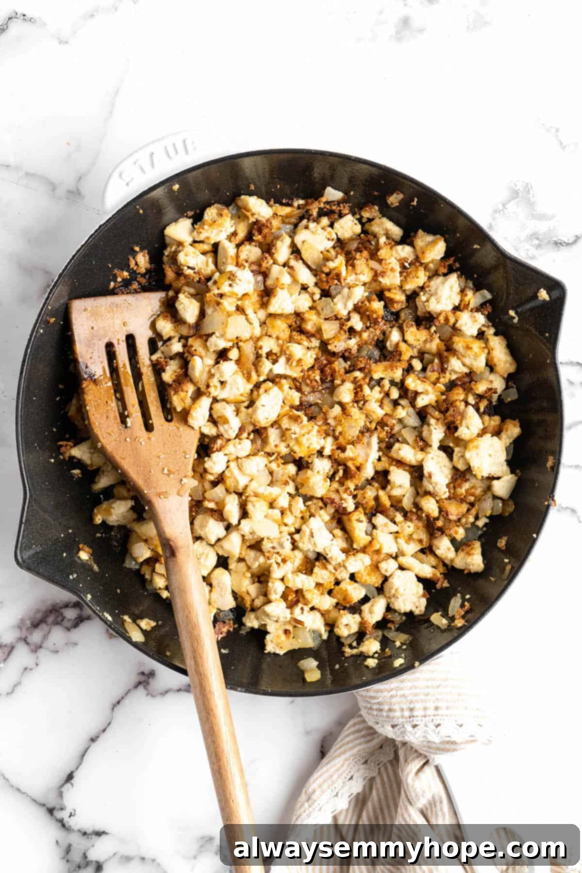 Homemade Chipotle Sofritas 5 Crumbled extra-firm tofu cooking and browning in a cast iron skillet