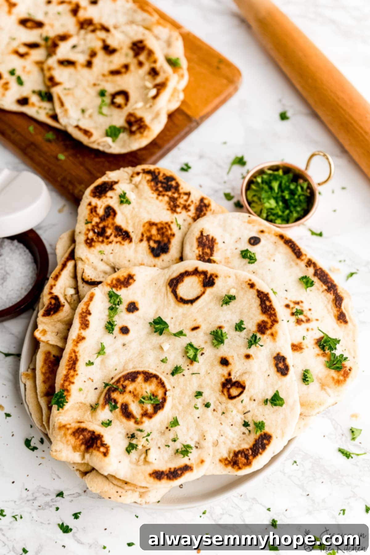 Delicious Homemade Vegan Naan 2 Plate of vegan naan loaves, garnished with fresh herbs.