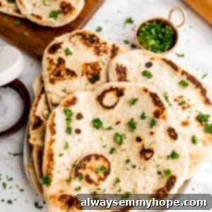 Delicious Homemade Vegan Naan 14 Overhead shot of stack of naan bread on a table.