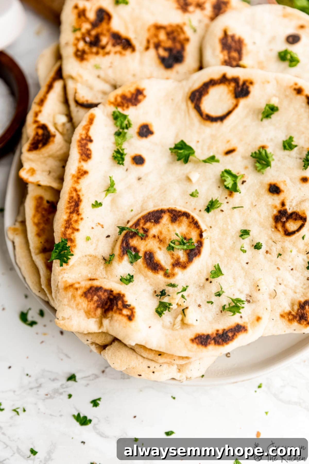 Delicious Homemade Vegan Naan 4 Stack of vegan naan loaves on a plate, ready to serve.