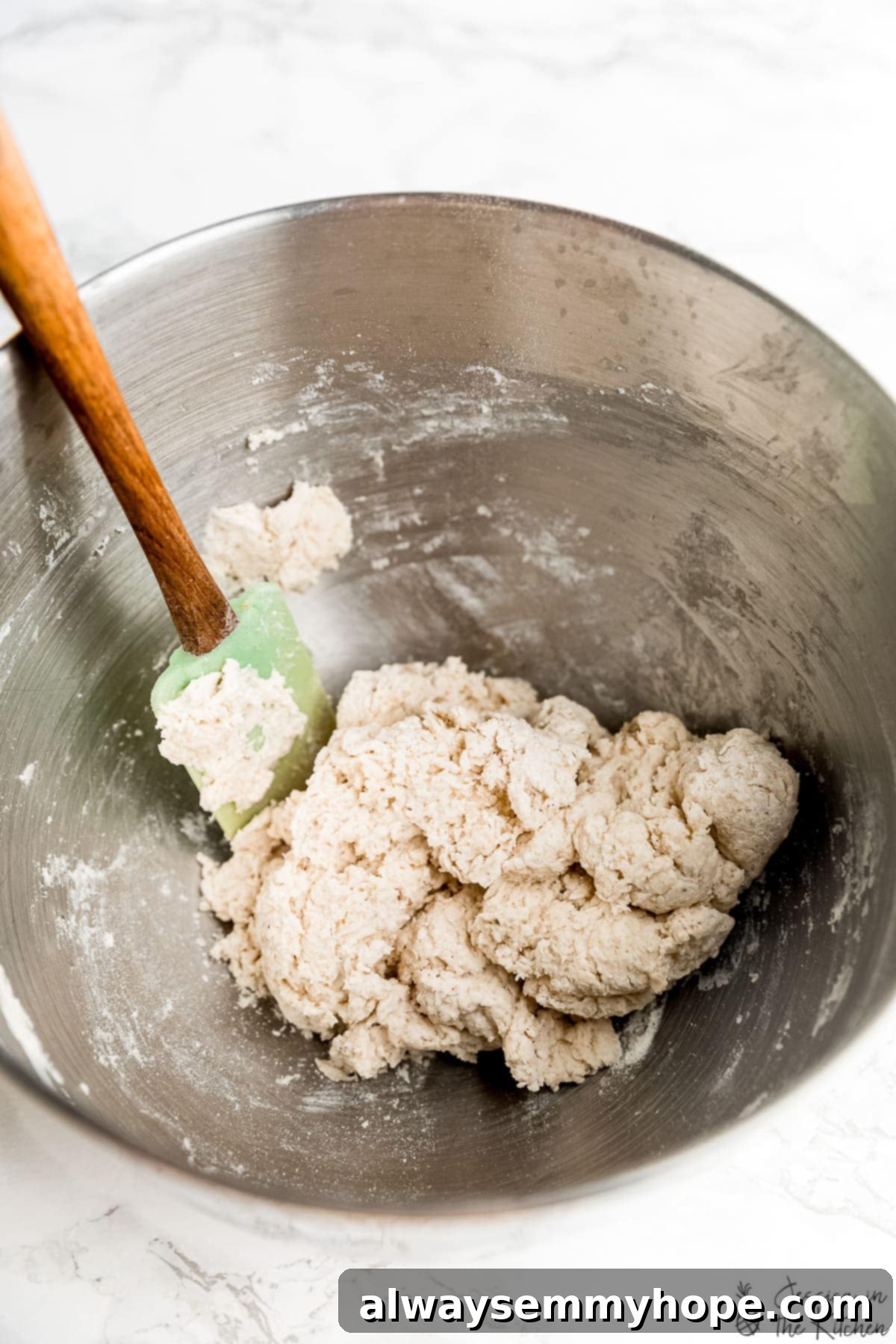 Delicious Homemade Vegan Naan 5 Shaggy vegan naan dough being mixed in a bowl.