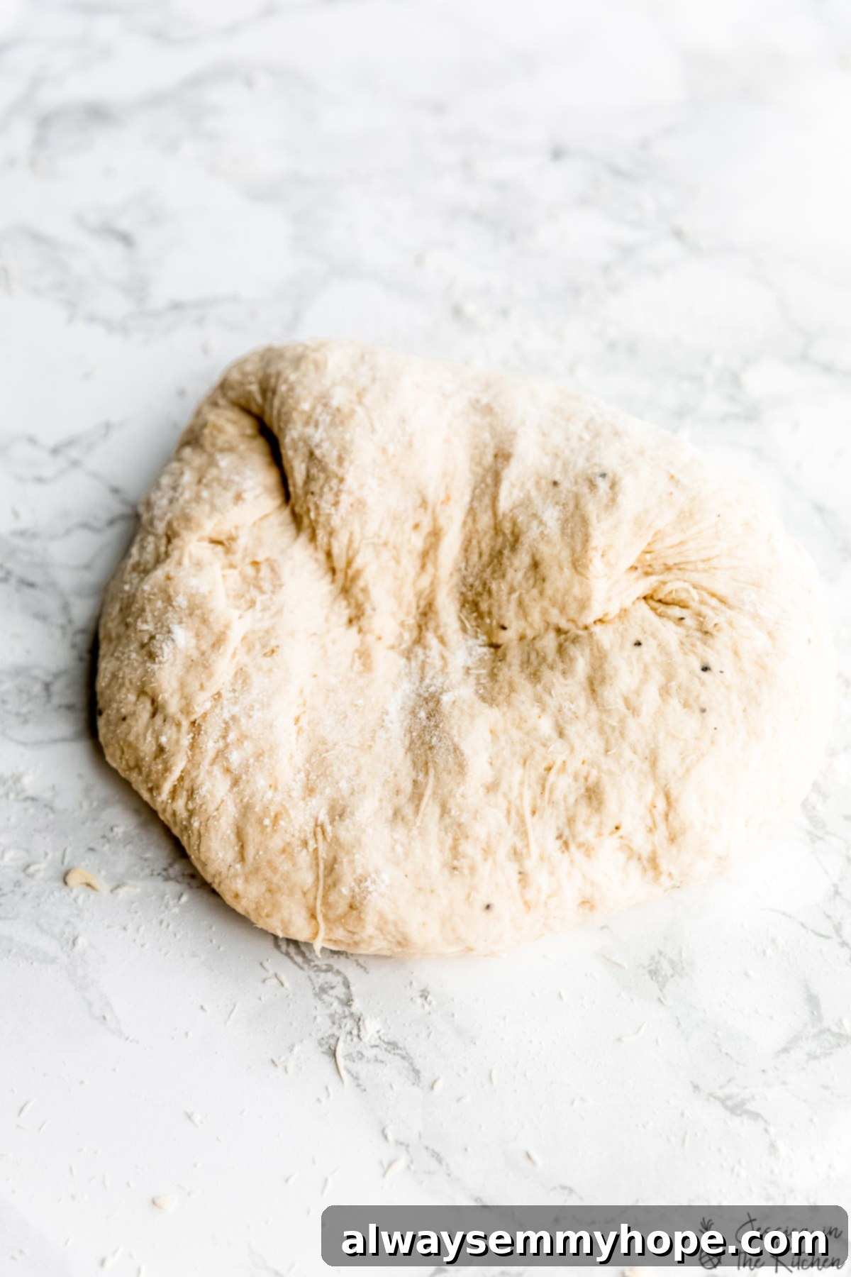 Delicious Homemade Vegan Naan 6 Vegan naan dough on a floured countertop, ready for kneading.