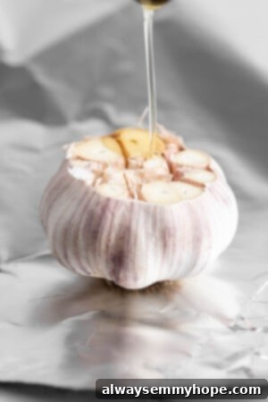 Pouring oil onto cut head of garlic