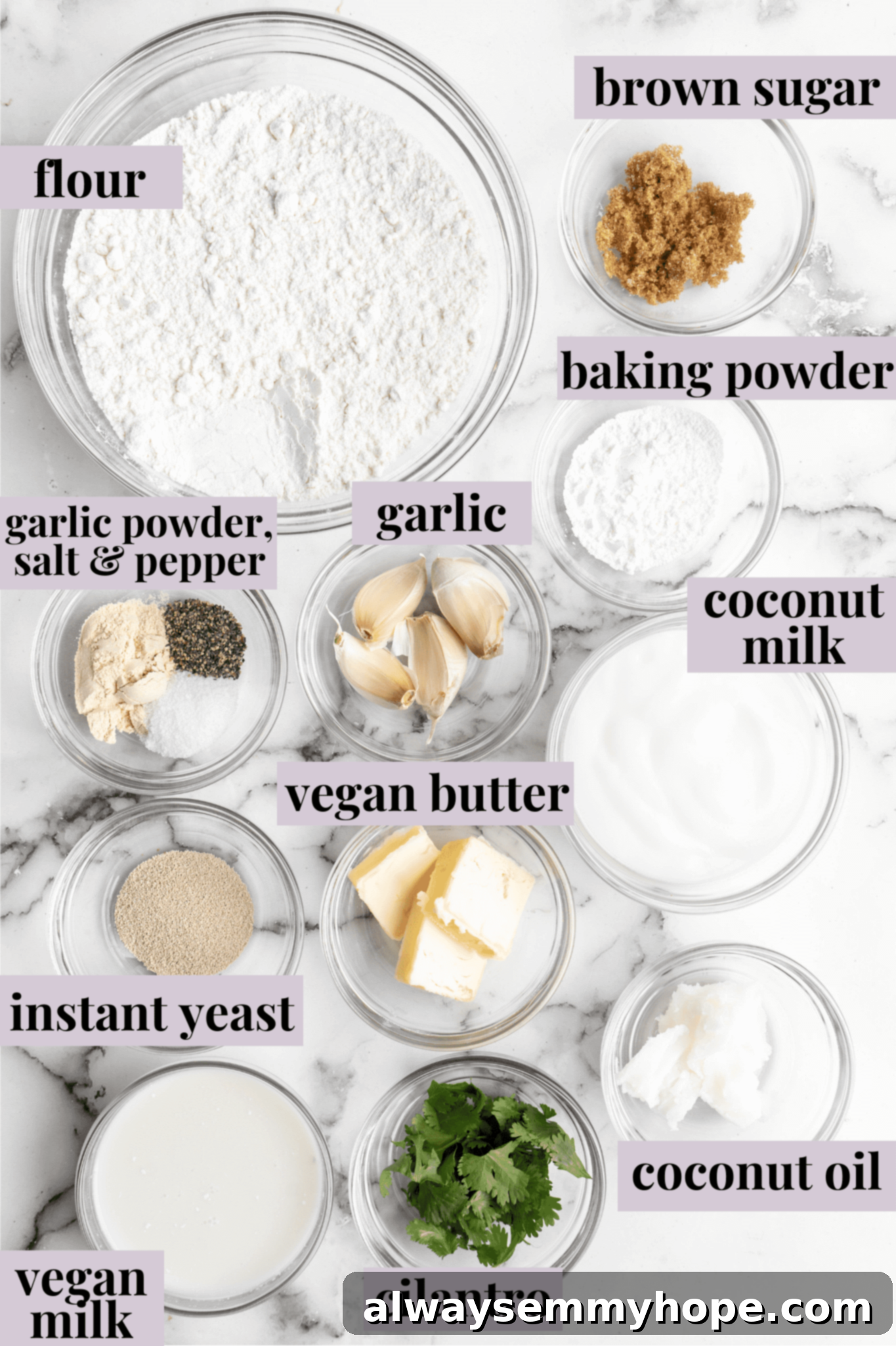 This vegan garlic naan recipe is chewy, soft, and easy to make at home! It's full of garlic flavour and perfect for pairing with curry! Overhead view of all ingredients for vegan garlic naan laid out on a clean kitchen surface.