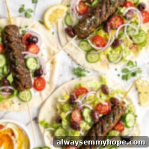 Overhead view of kofta served on pita bread with veggies