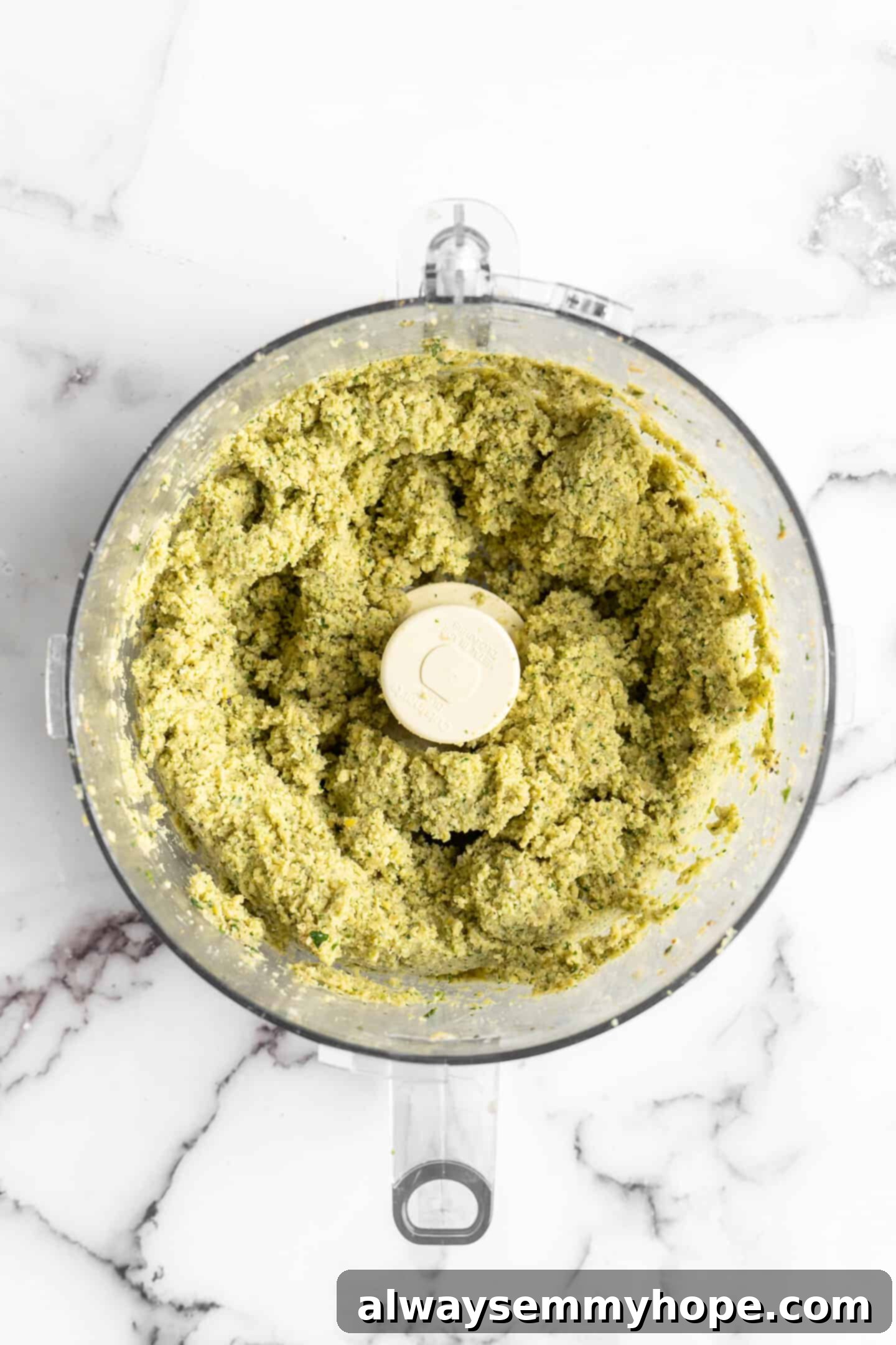 This homemade falafel recipe is just like the kind they make at restaurants. Fluffy on the inside, crispy on the outside, and so delicious! Falafel mixture in food processor