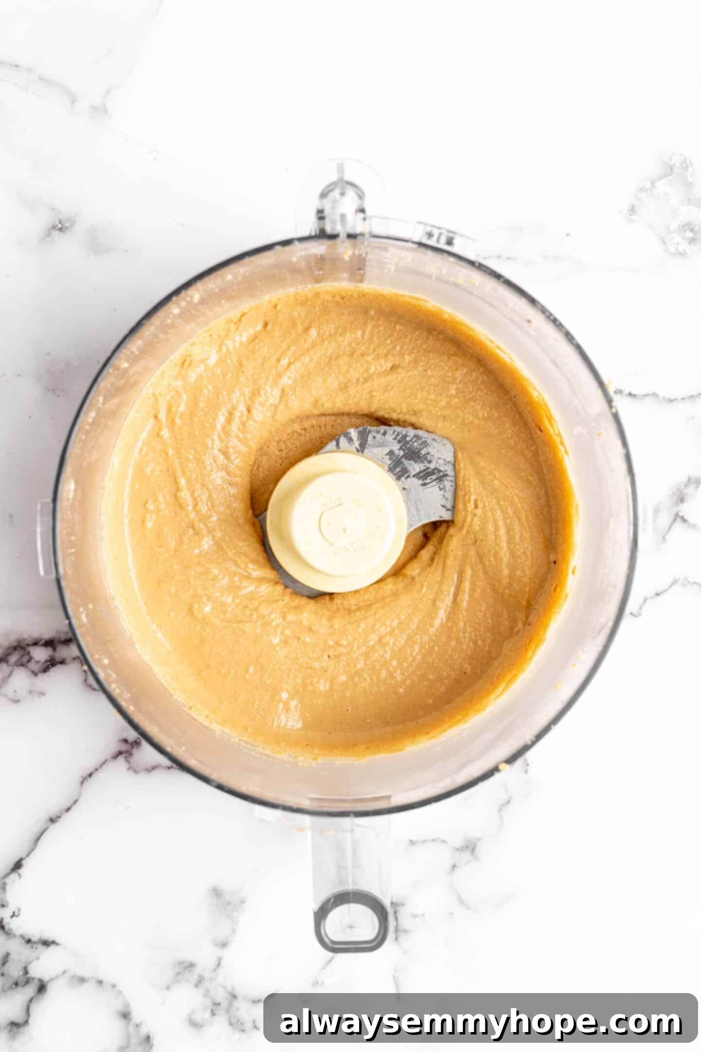 Overhead view of homemade peanut butter in food processor