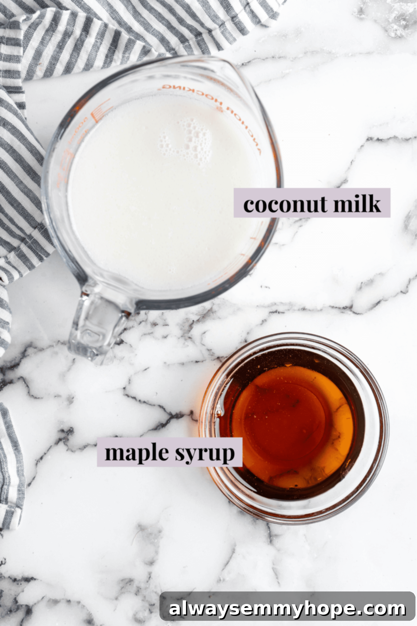 Overhead shot of two ingredients: a can of full-fat coconut milk and a bottle of maple syrup, the simple components for homemade vegan condensed milk