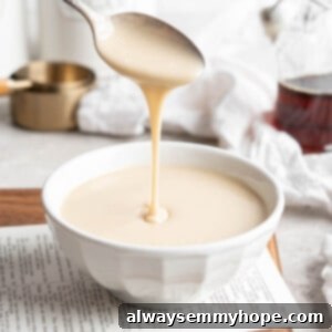 Spoon drizzling vegan condensed milk into bowl, showcasing its creamy texture for dairy-free desserts
