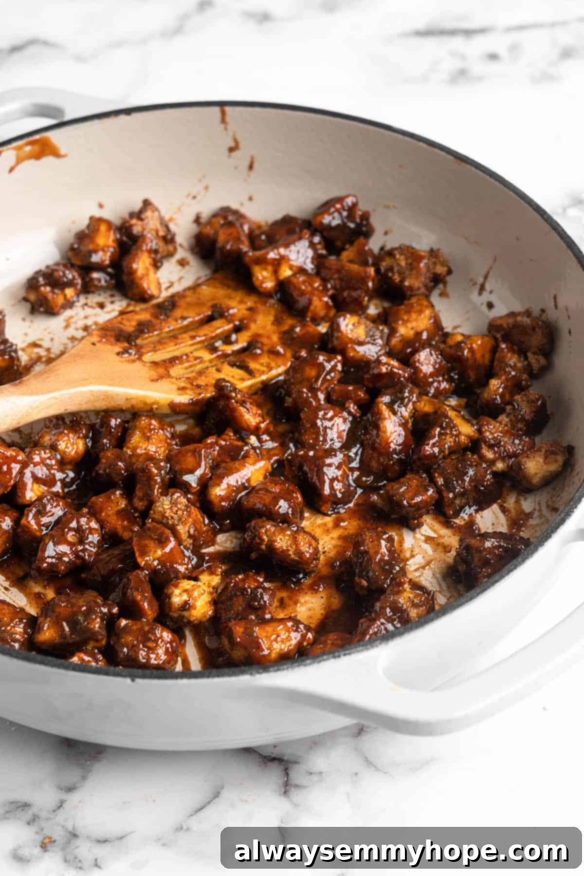 This Jamaican jerk tofu is the real deal! It's spicy, saucy, and just a little bit sweet. It's also super easy to make for a weeknight meal! Saucy Jamaican jerk tofu in skillet