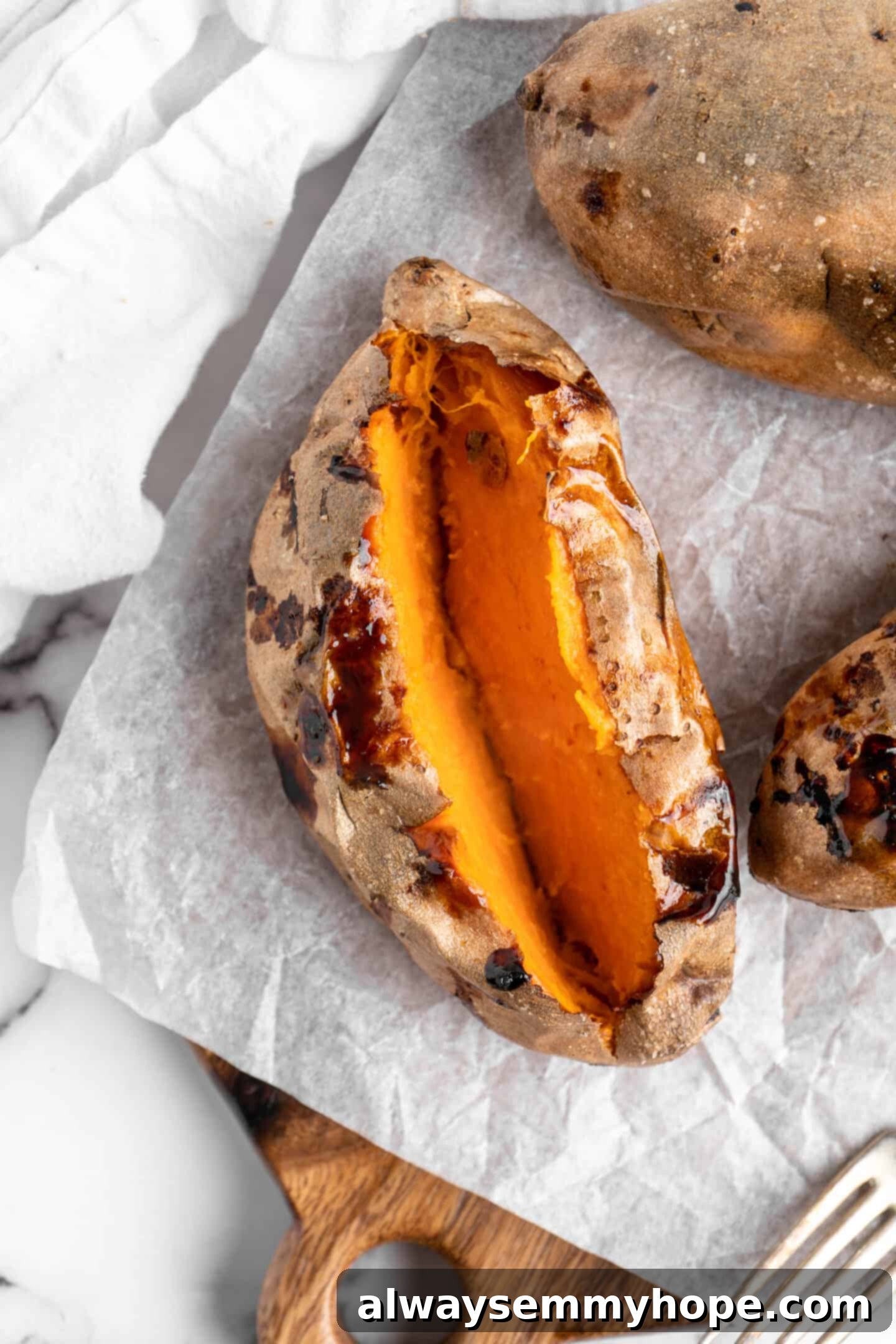 Cut air fryer sweet potato, showing smooth inside.
