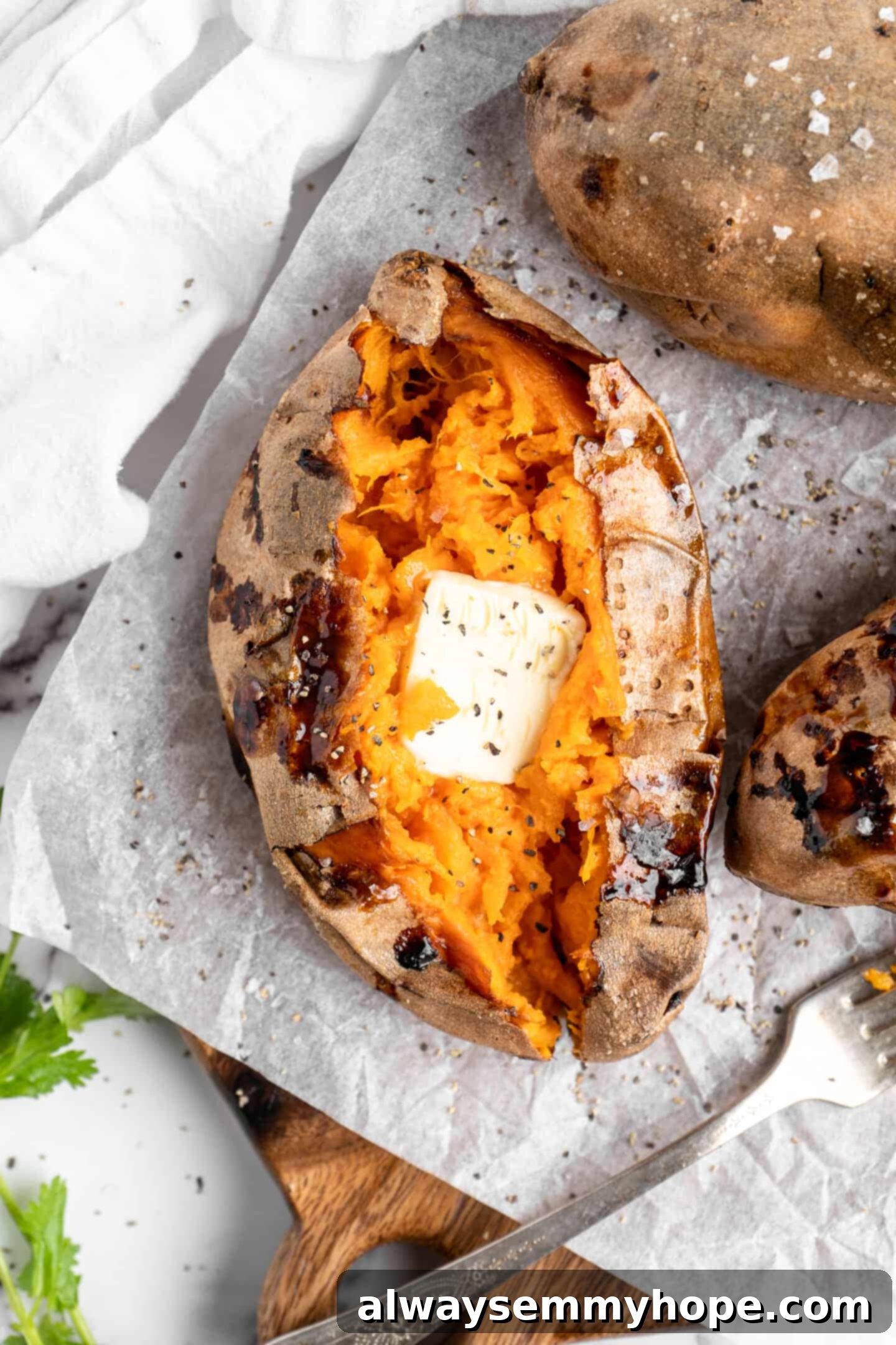 Air fryer sweet potato topped with butter.