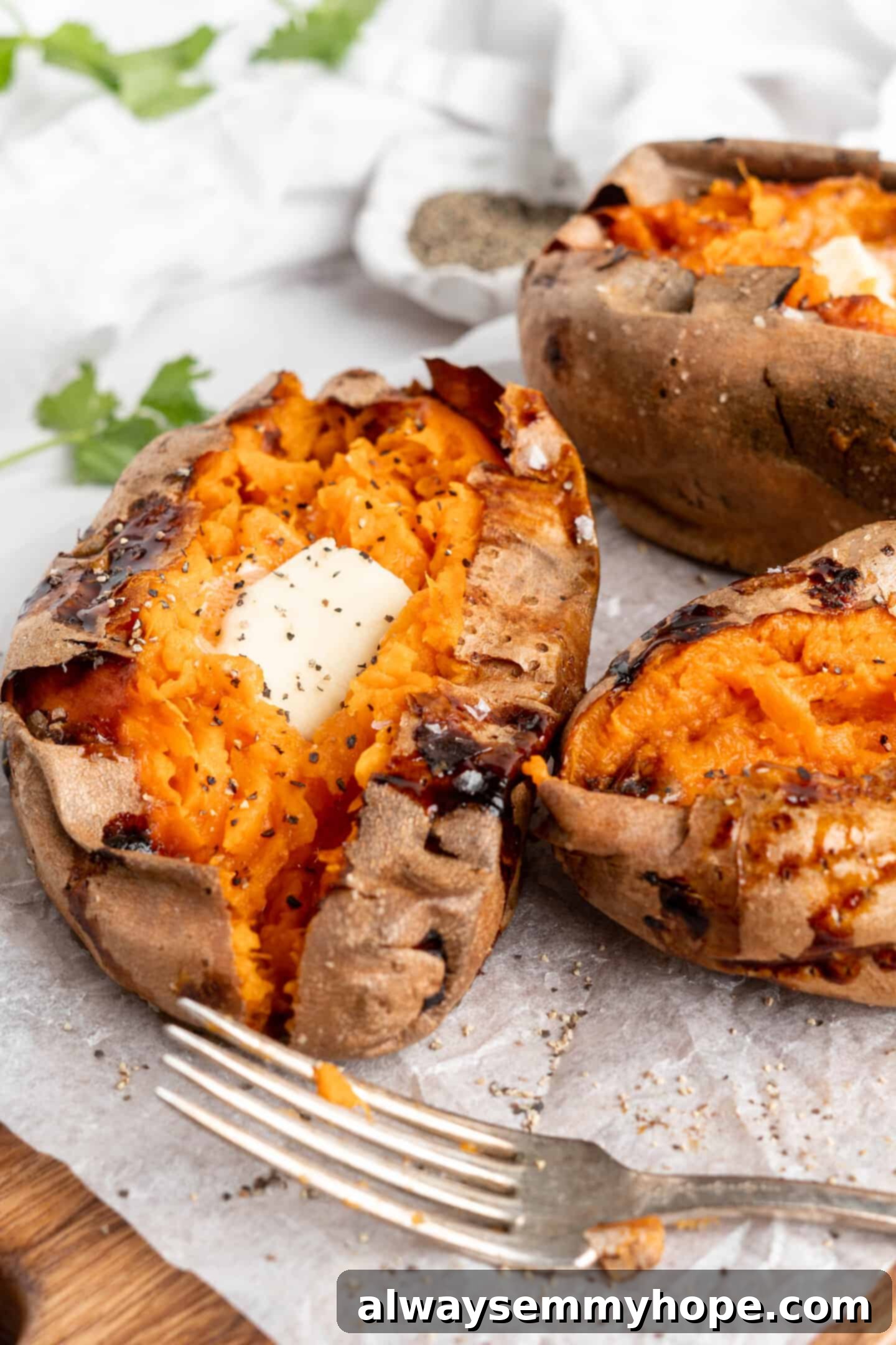 Air fryer sweet potatoes topped with butter.