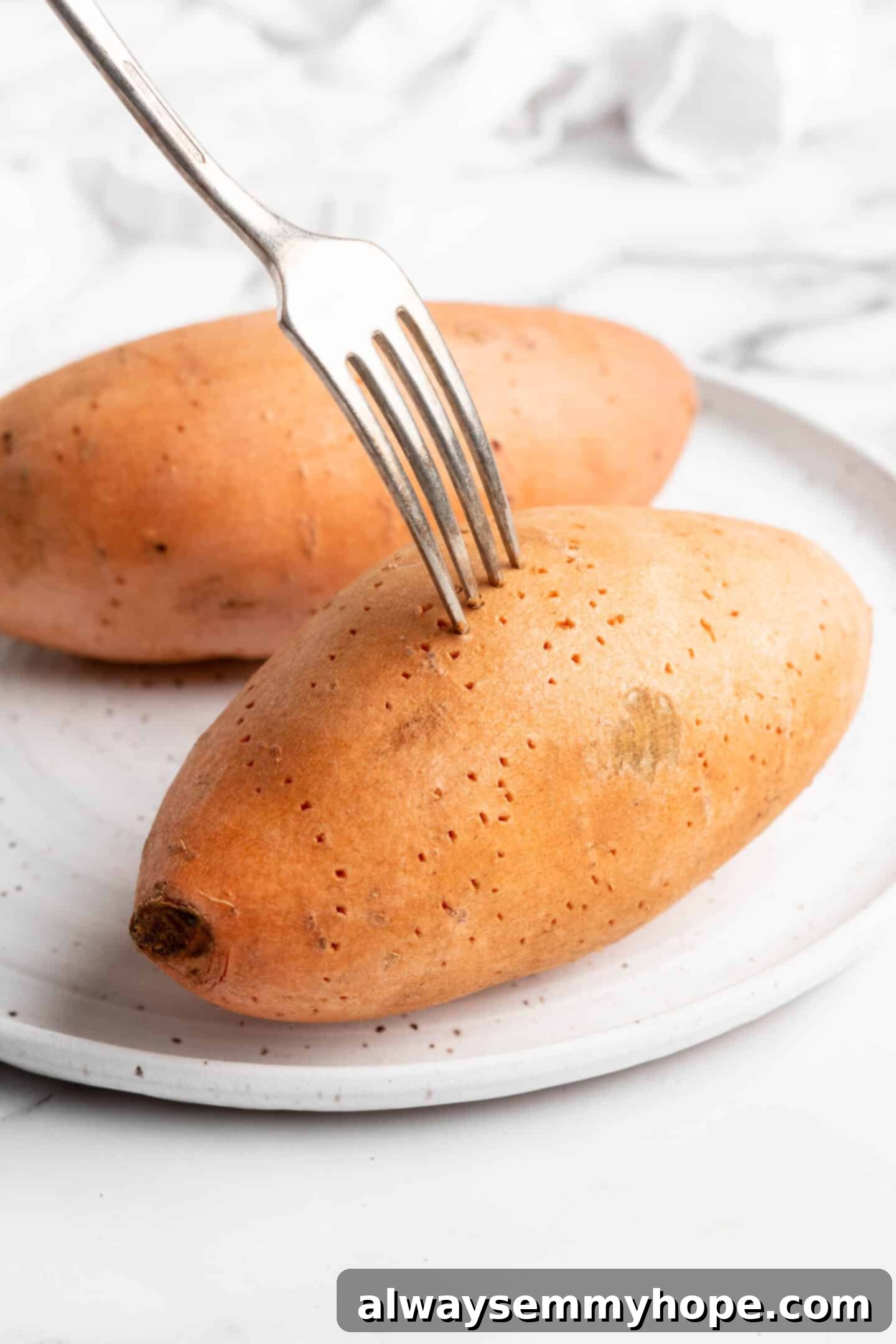 Poking a sweet potato with a fork.