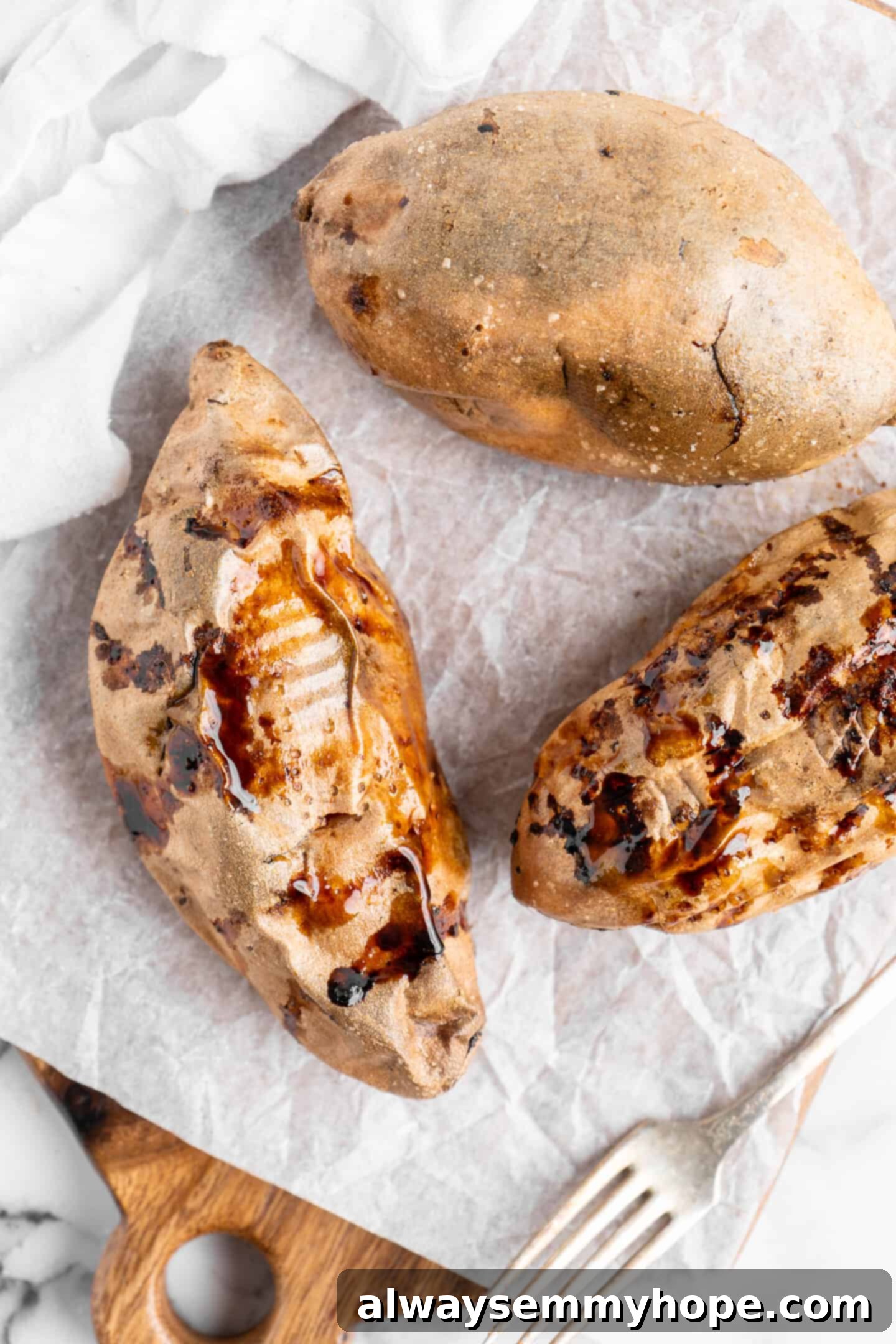 Air fryer sweet potatoes on parchment paper.