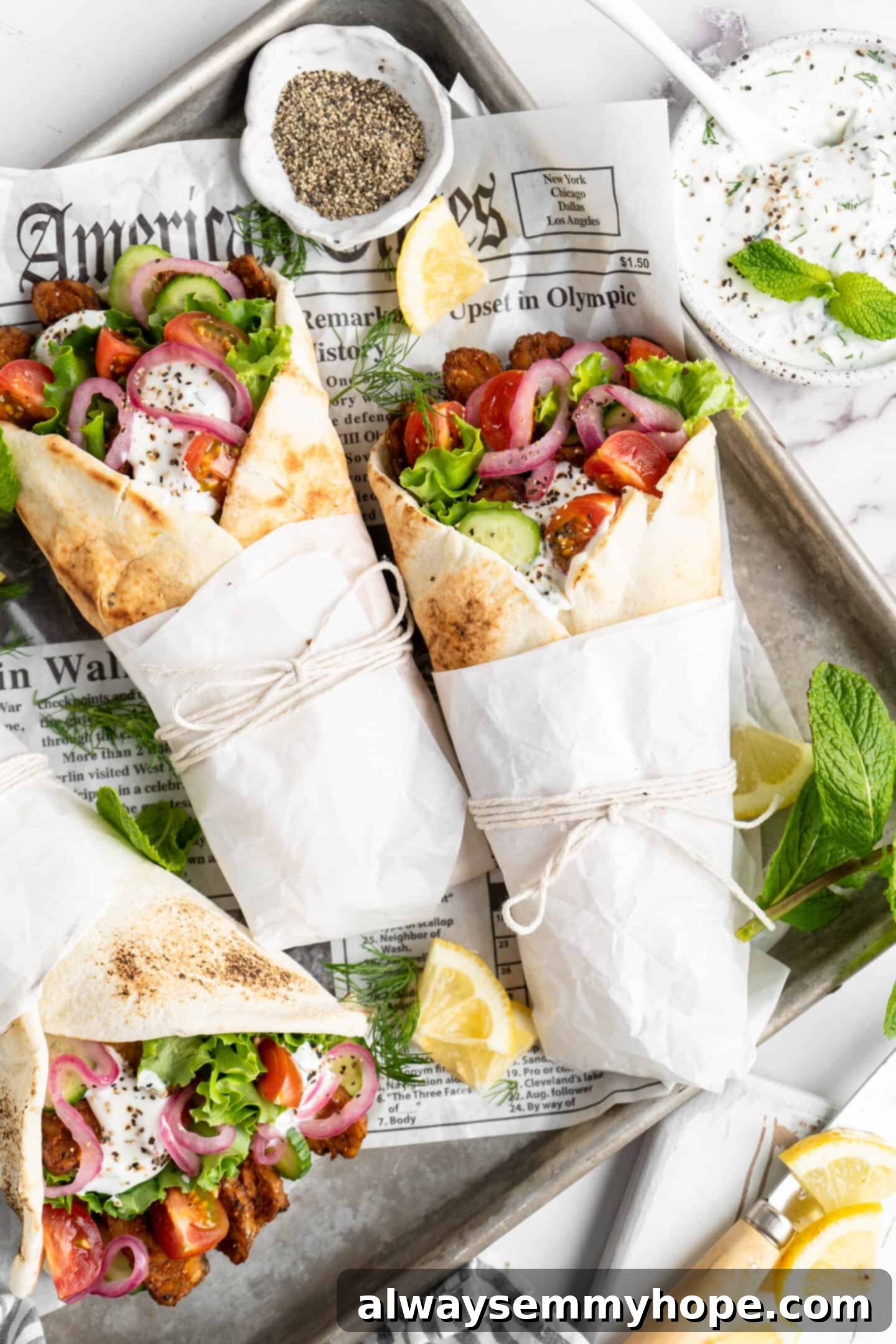 Tempeh vegan gyros loaded with fresh toppings, showcasing a colorful and appetizing meal.