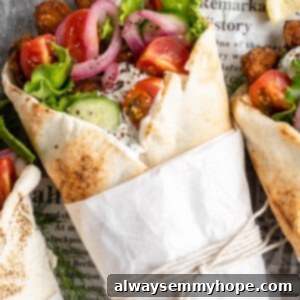 Vegan gyros wrapped in parchment and string, ready to be eaten.