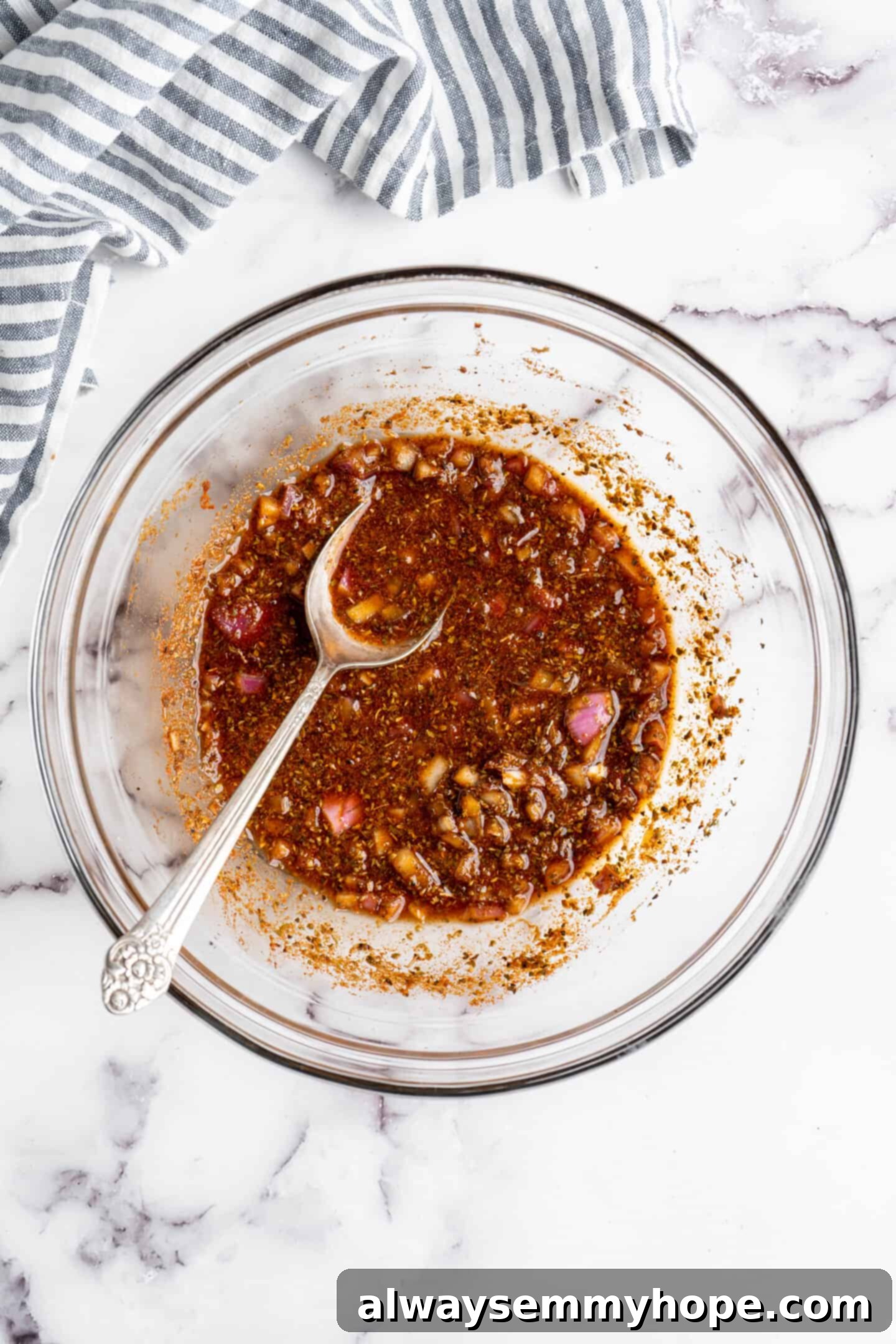 A bowl filled with a rich, aromatic tempeh marinade, ready for the sliced tempeh.