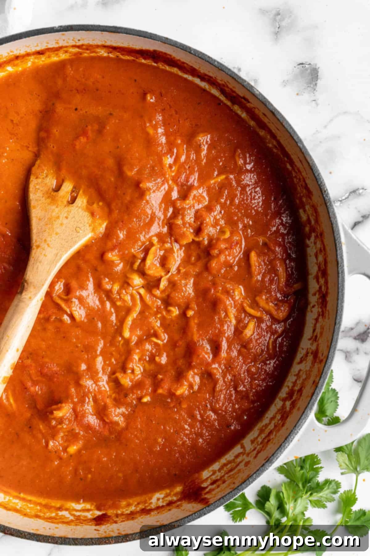 Vegan birria tacos use king oyster mushrooms to mimic the texture/flavour of the original. They’re smoky, crispy, and perfect for dipping! Overhead view of birria sauce in a pot.