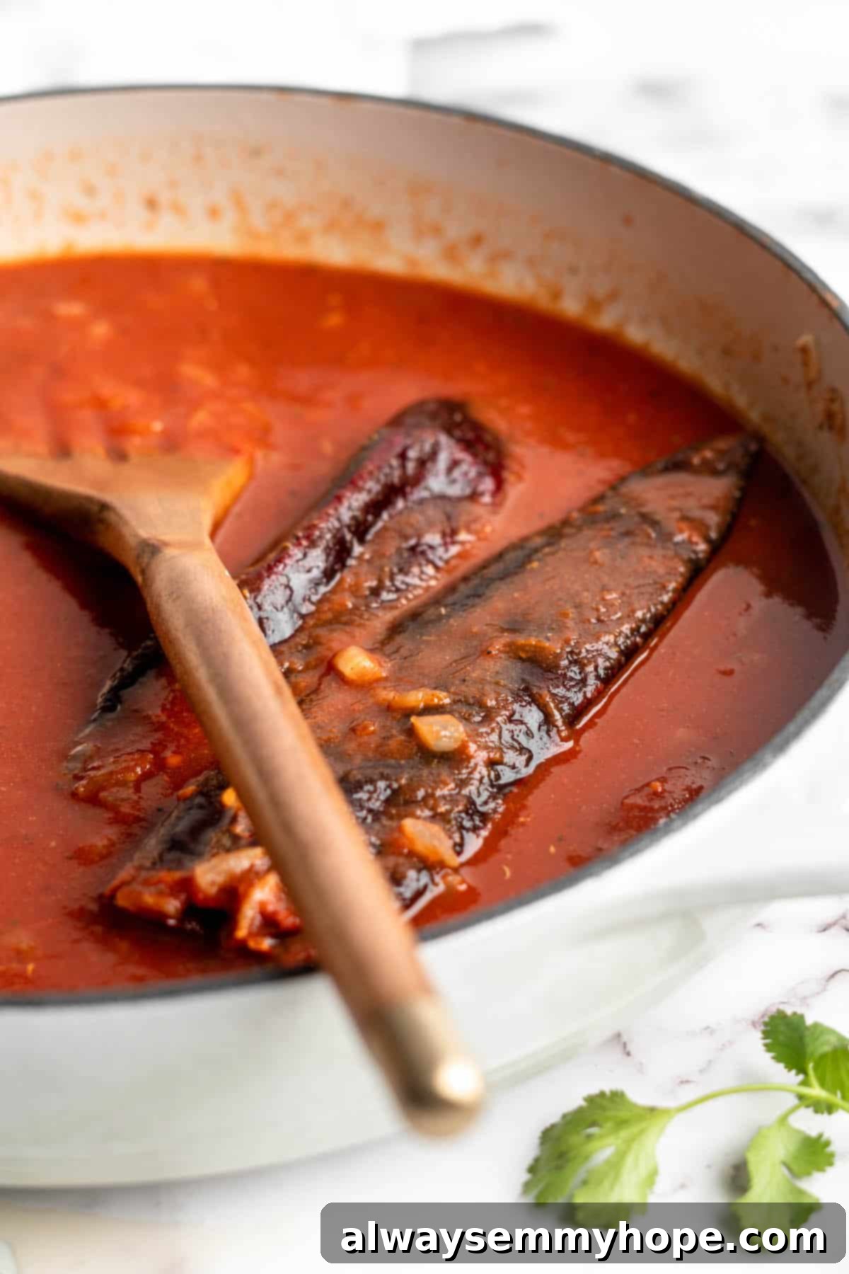 Vegan birria tacos use king oyster mushrooms to mimic the texture/flavour of the original. They’re smoky, crispy, and perfect for dipping! Birria sauce simmering with guajillo chiles.