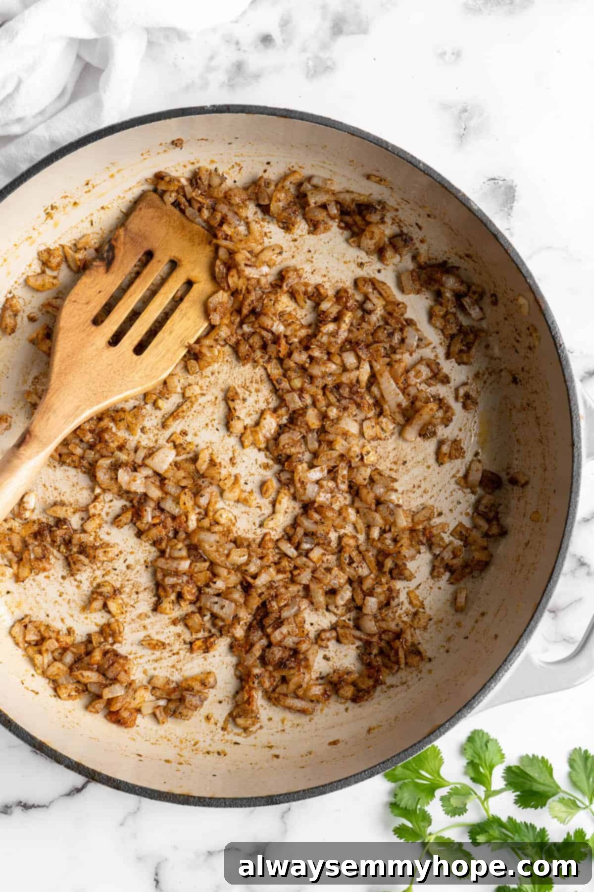 Vegan birria tacos use king oyster mushrooms to mimic the texture/flavour of the original. They’re smoky, crispy, and perfect for dipping! Overhead view of cooked aromatics in a pot.