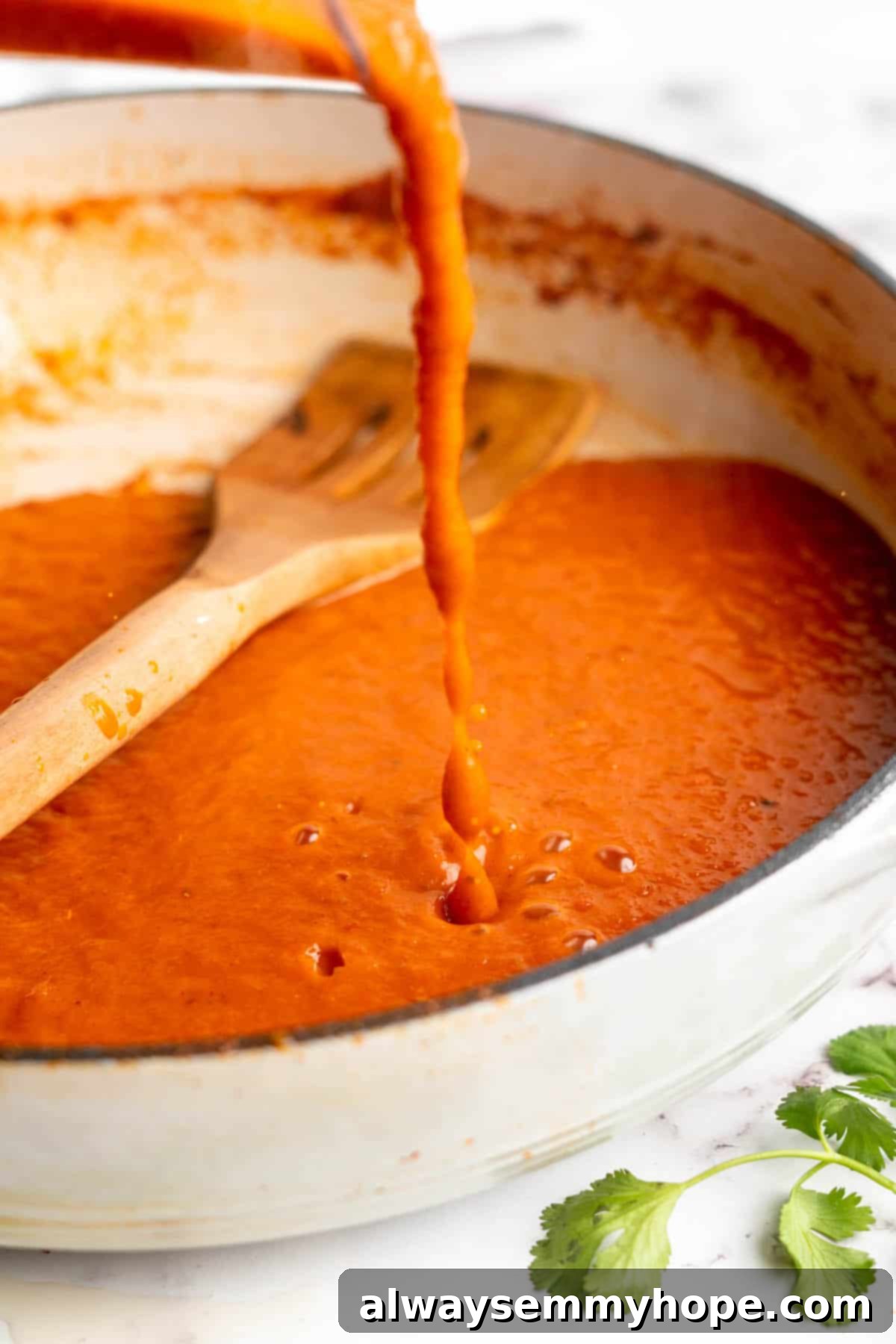 Vegan birria tacos use king oyster mushrooms to mimic the texture/flavour of the original. They’re smoky, crispy, and perfect for dipping! Pouring blended birria sauce back into a pan.