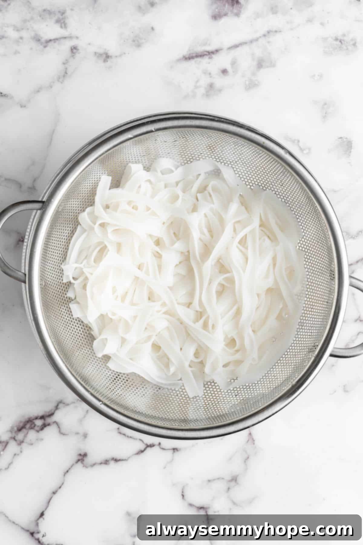Overhead view of rice noodles in colander