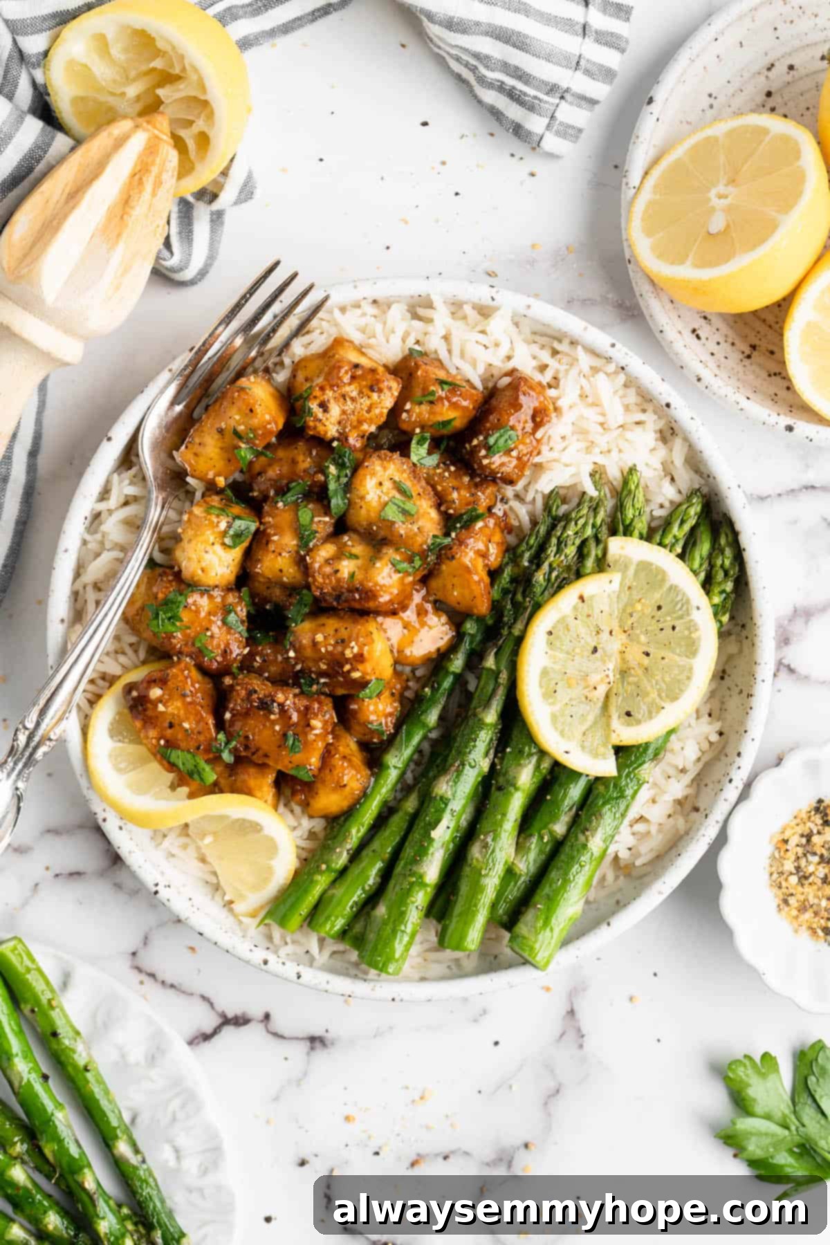 This lemon pepper tofu is crispy and saucy, with the perfect chewy texture. It takes minutes to make and it's absolutely packed with flavour! Overhead view of a plate with lemon pepper tofu, rice, and asparagus.