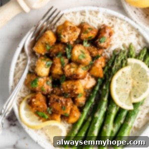 Zesty Lemon Pepper Tofu 2 Overhead view of lemon pepper tofu with rice and asparagus on plate