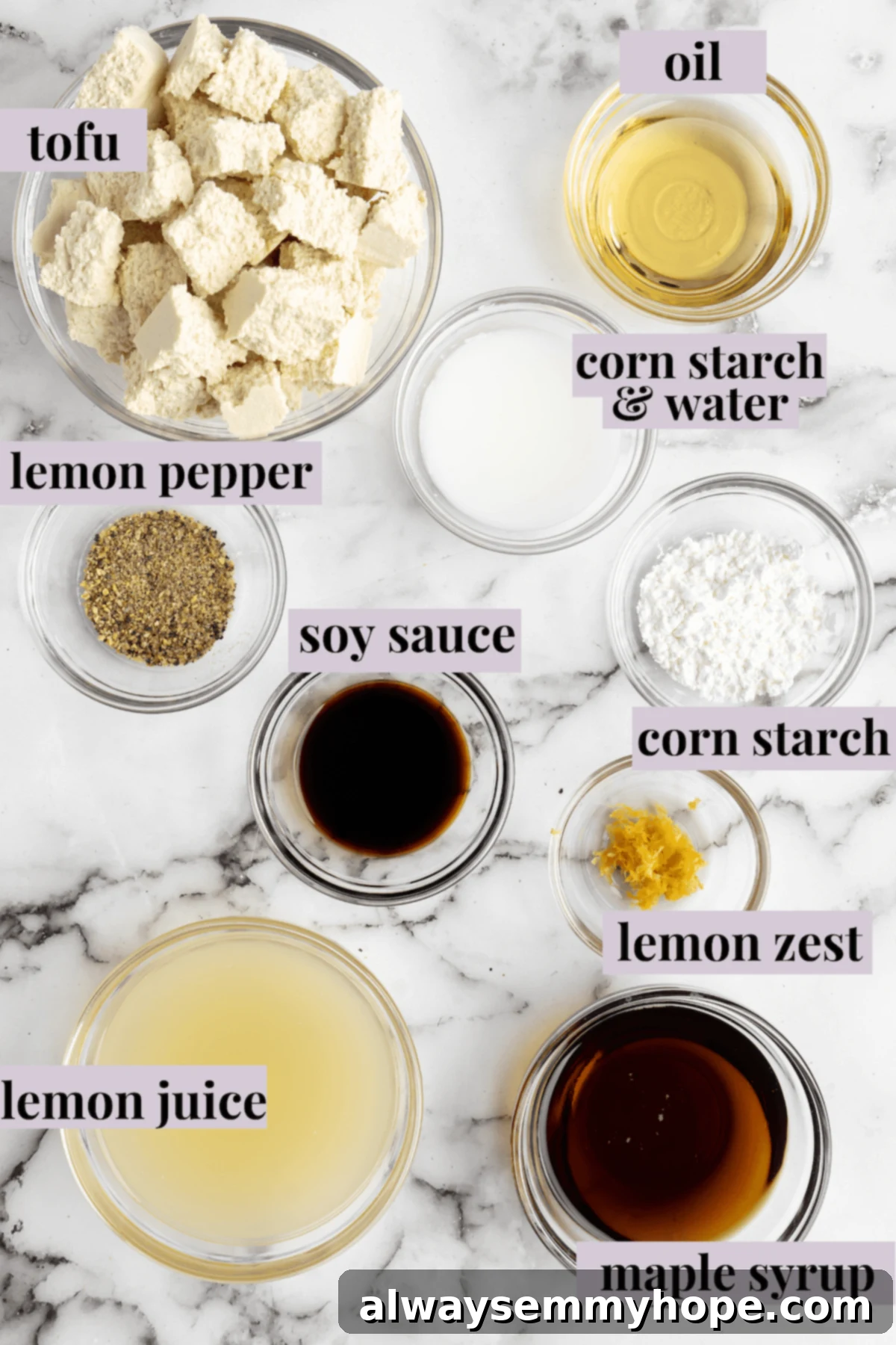 This lemon pepper tofu is crispy and saucy, with the perfect chewy texture. It takes minutes to make and it's absolutely packed with flavour! Overhead view of ingredients for lemon pepper tofu with labels.