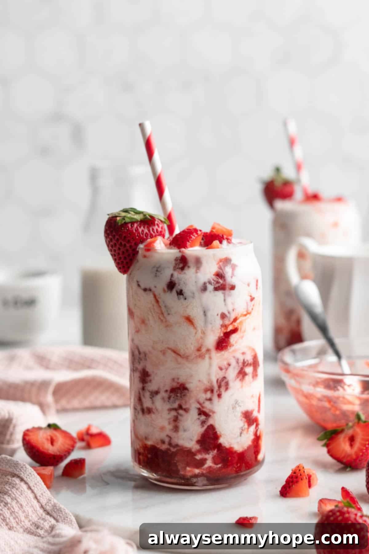 How to make vegan Korean strawberry milk! This easy recipe is made with 4 simple ingredients and each glass is full of fresh strawberries. A single glass of vegan Korean strawberry milk, close-up, highlighting the fresh strawberry pieces and creamy texture.