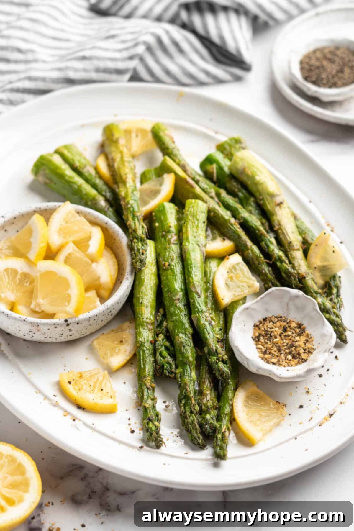 This easy lemon pepper air fryer asparagus is the perfect side dish for busy weeknights. It's done in just 10 minutes from start to finish! A serving platter showcasing perfectly cooked air fryer asparagus, ready to be enjoyed as a healthy and delicious side dish.