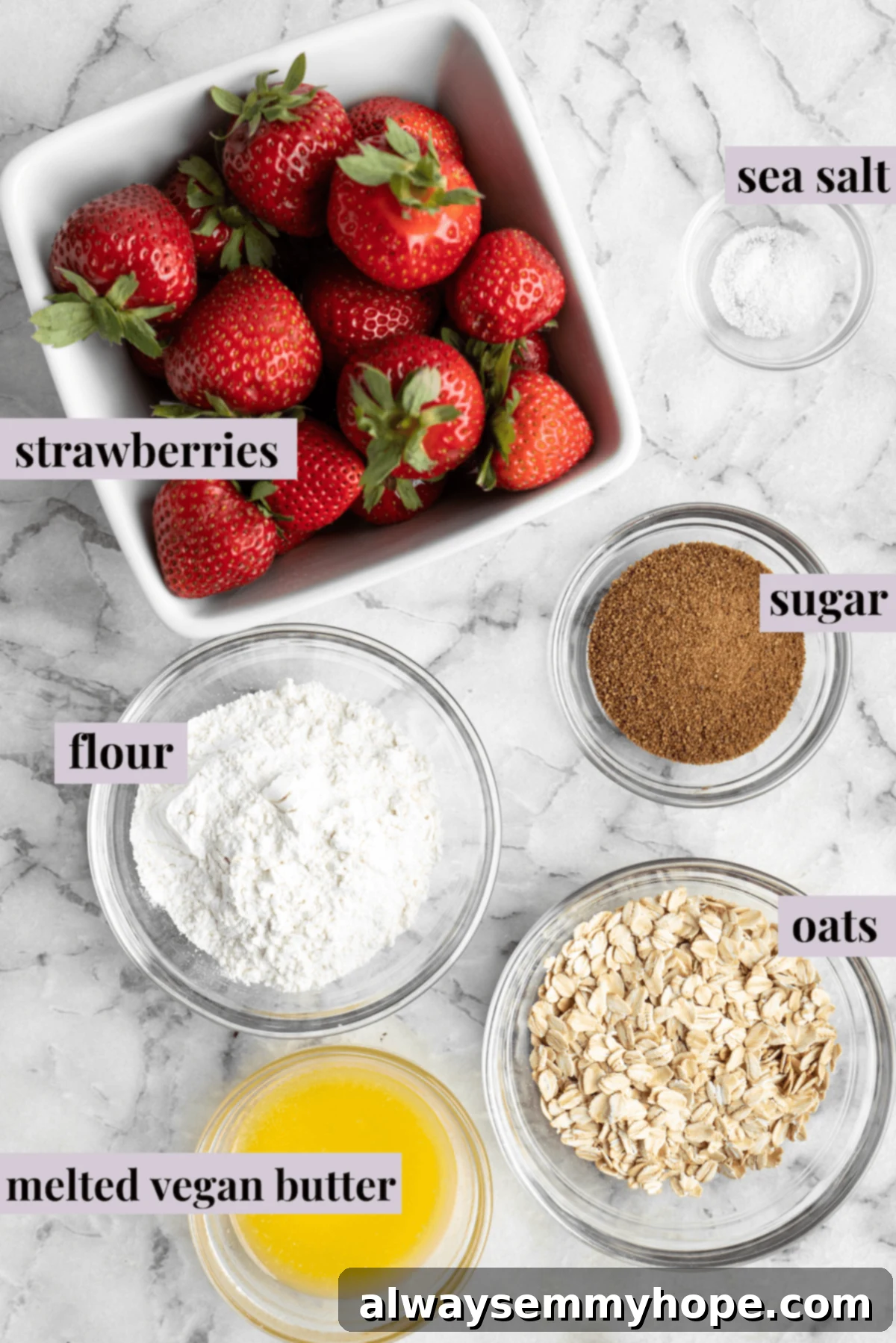This vegan strawberry crumble is easy as can be! You only need 5 ingredients and a few minutes of assembly for the perfect summer dessert. Overhead view of ingredients for strawberry crumble with labels