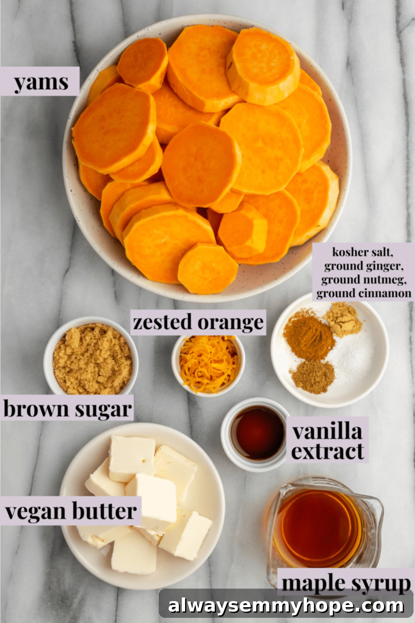 This easy, vegan candied yams recipe makes a sweet, sticky, and delicious plant-based side dish to accompany any special meal. Overhead view of all the fresh ingredients laid out for making vegan candied yams: yams, vegan butter, brown sugar, maple syrup, orange, and spices.