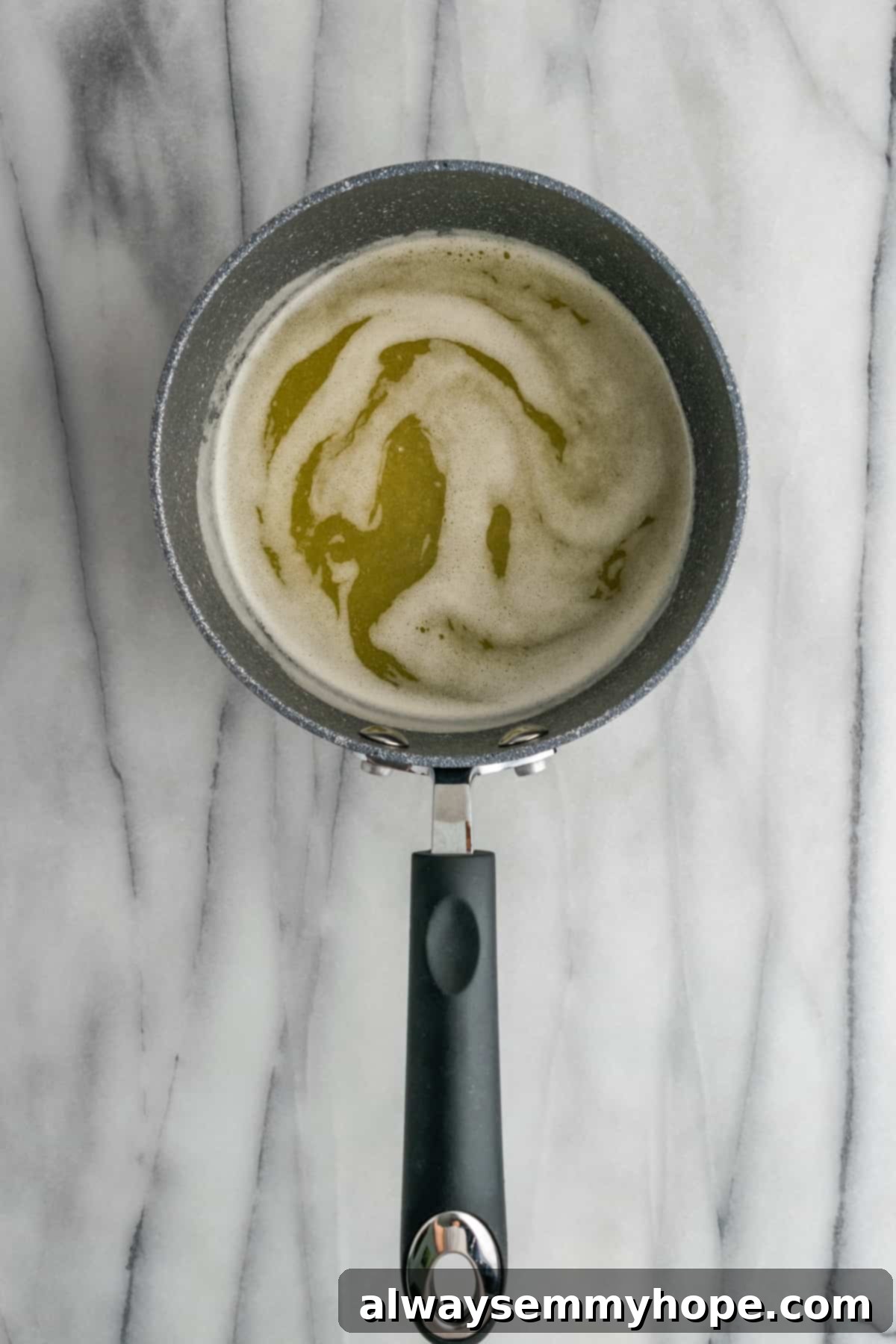 Melted vegan butter in a saucepan, forming a rich base for the candied yam sauce. Melted golden vegan butter bubbling gently in a saucepan, forming the base of the sweet sauce.