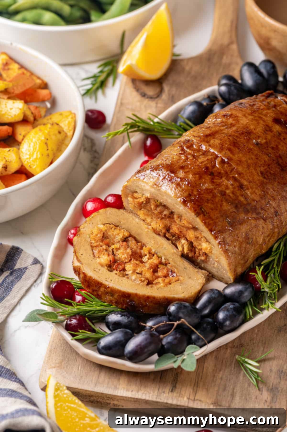 This homemade vegan turkey recipe is supremely flavourful and the perfect addition to any Thanksgiving table or holiday dinner! Vegan turkey on platter with one slice cut to show stuffing inside