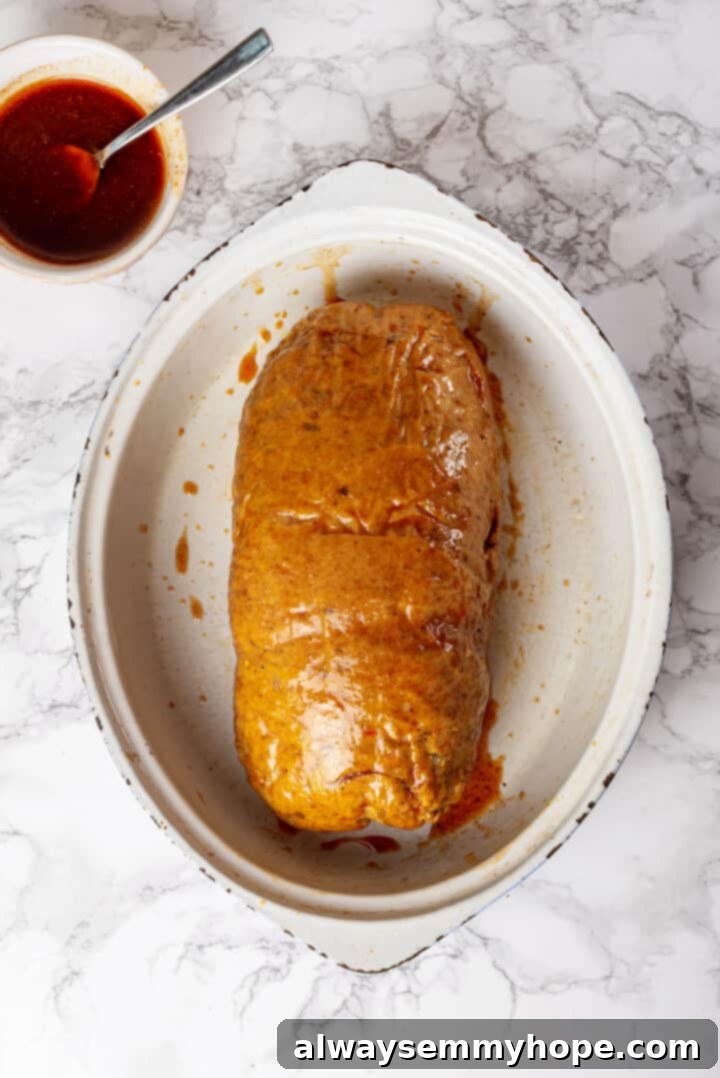 This homemade vegan turkey recipe is supremely flavourful and the perfect addition to any Thanksgiving table or holiday dinner! Overhead view of vegan turkey in roasting pan