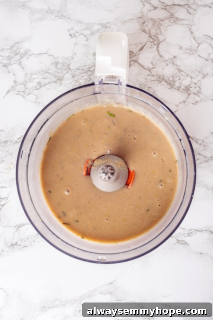 This homemade vegan turkey recipe is supremely flavourful and the perfect addition to any Thanksgiving table or holiday dinner! Overhead view of pureed beans and seasonings in food processor